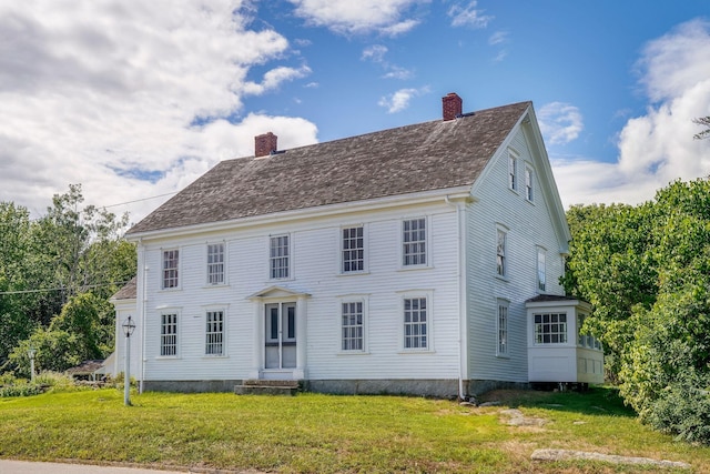 colonial home with a front lawn