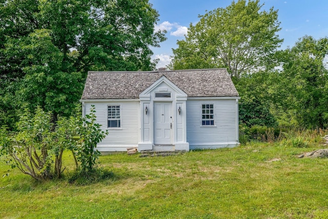 view of outbuilding with a yard