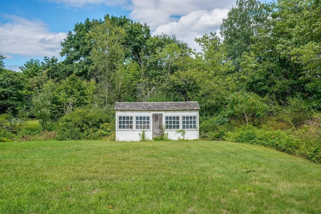 view of outdoor structure with a lawn