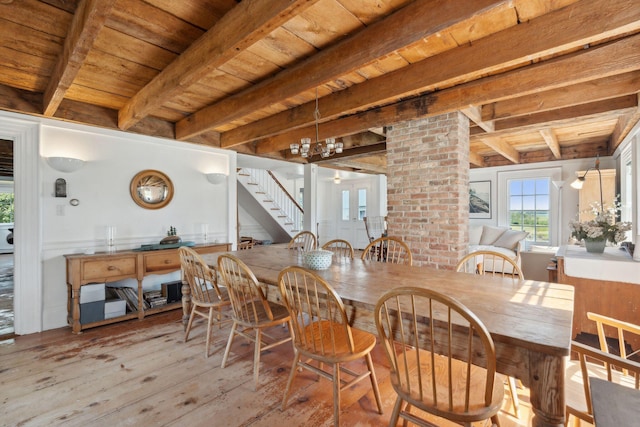 dining space with a chandelier, light hardwood / wood-style floors, beamed ceiling, and wood ceiling