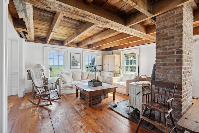 interior space featuring beamed ceiling, wooden ceiling, and a wealth of natural light