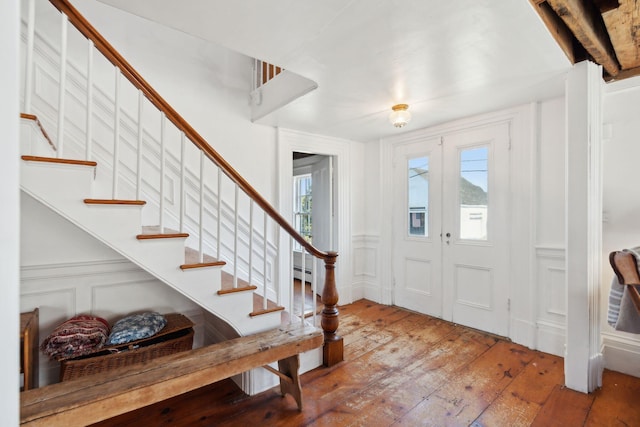 foyer with beam ceiling and wood-type flooring