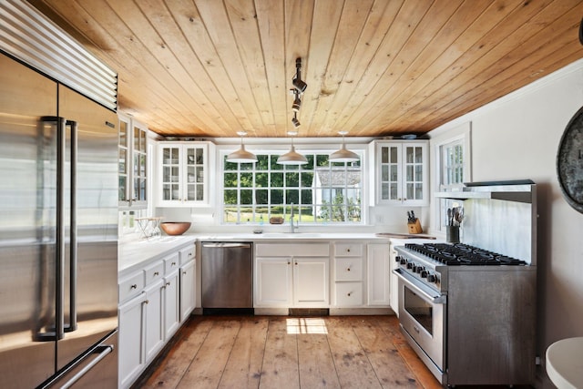 kitchen with high quality appliances, white cabinets, decorative light fixtures, light hardwood / wood-style floors, and wood ceiling