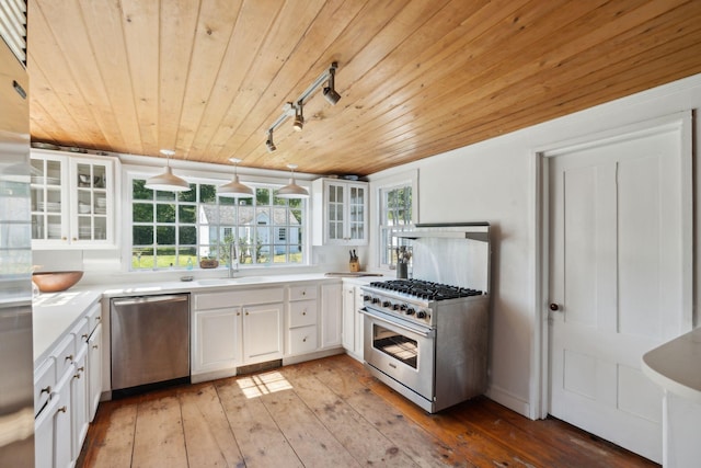 kitchen featuring appliances with stainless steel finishes, wood ceiling, sink, pendant lighting, and white cabinets