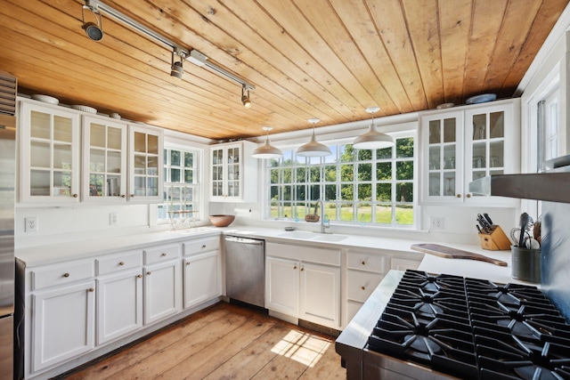 kitchen with white cabinetry, dishwasher, hanging light fixtures, and light hardwood / wood-style floors