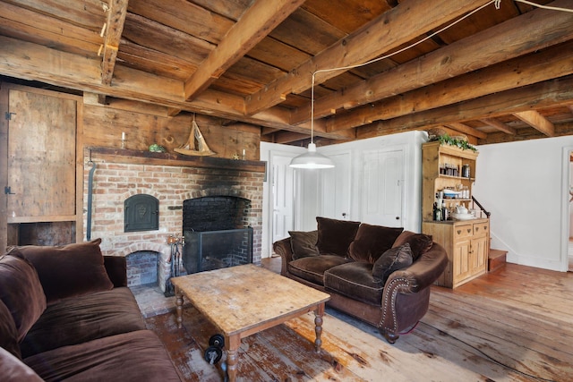 living room with beam ceiling, a fireplace, wooden ceiling, and light wood-type flooring