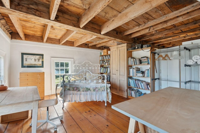 bedroom with light hardwood / wood-style flooring, beamed ceiling, and wooden ceiling