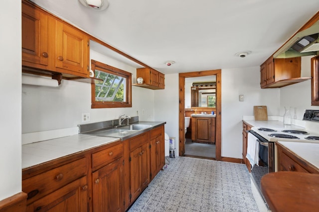 kitchen featuring white range with electric stovetop and sink