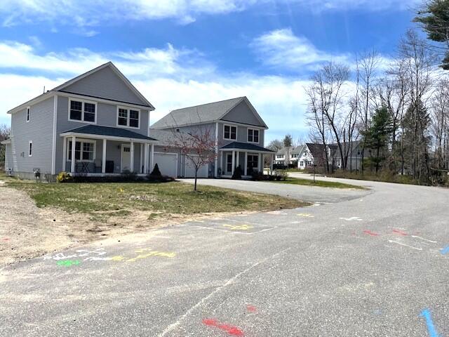 view of front facade featuring a porch and a garage