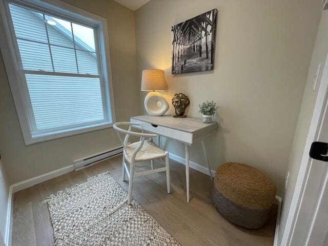 office area featuring light hardwood / wood-style flooring and a baseboard radiator