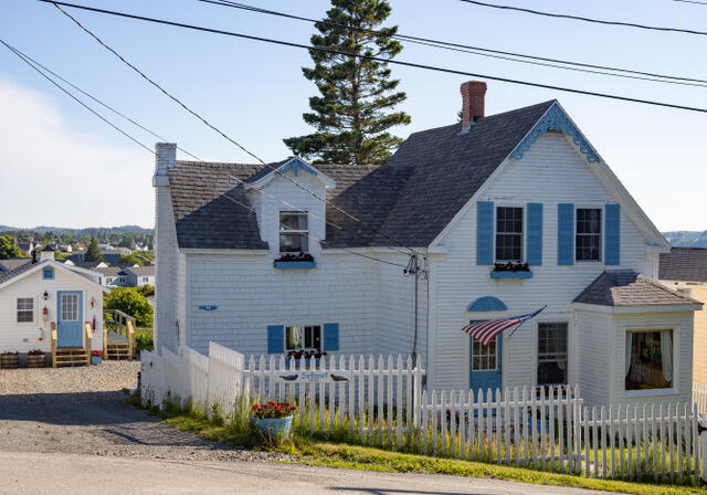 view of front of house with a fenced front yard and a chimney