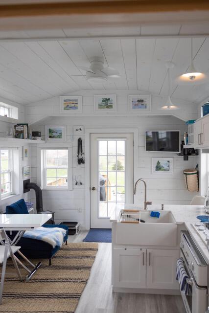 16 Monument St, Lubec, ME 04652 - kitchen with oven, light wood finished floors, vaulted ceiling, plenty of natural light, and white cabinets