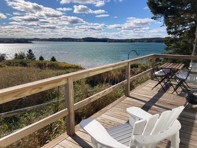 wooden deck featuring a water view