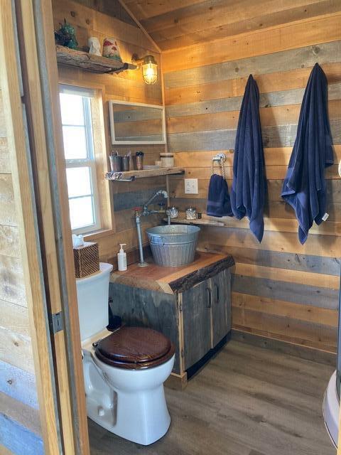16 Monument St, Lubec, ME 04652 - bathroom with wood finished floors, wooden walls, and lofted ceiling