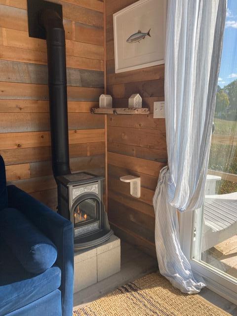16 Monument St, Lubec, ME 04652 - detailed view of wooden walls and a wood stove