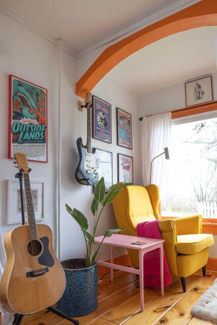 sitting room featuring ornamental molding and wood finished floors