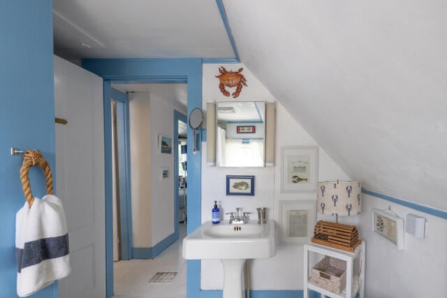 bathroom featuring vaulted ceiling