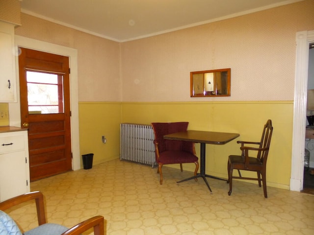 sitting room featuring radiator heating unit and ornamental molding