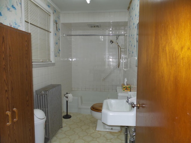 full bathroom featuring sink, toilet, ornamental molding, shower with separate bathtub, and radiator heating unit