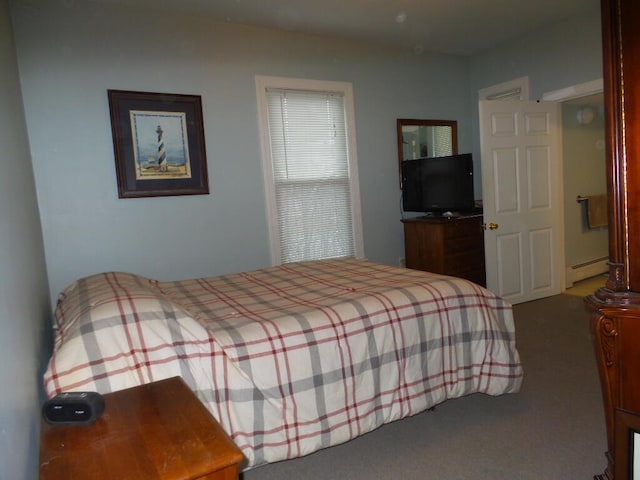 carpeted bedroom featuring a baseboard heating unit