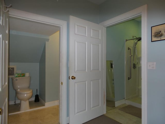 bathroom with a shower and toilet