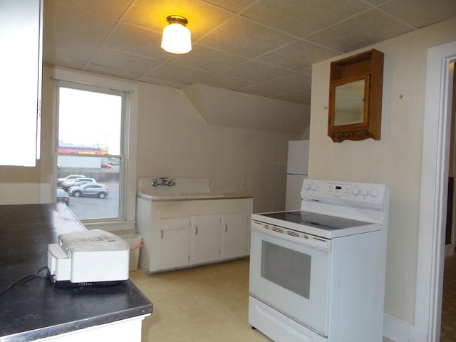 kitchen with white appliances, white cabinetry, a drop ceiling, and sink