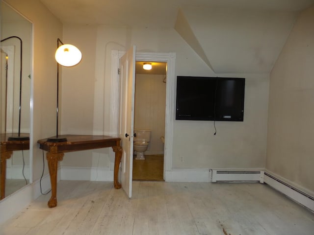 interior space with light hardwood / wood-style flooring and a baseboard heating unit