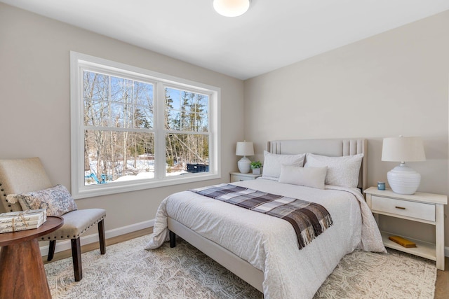 bedroom featuring light wood-type flooring and baseboards