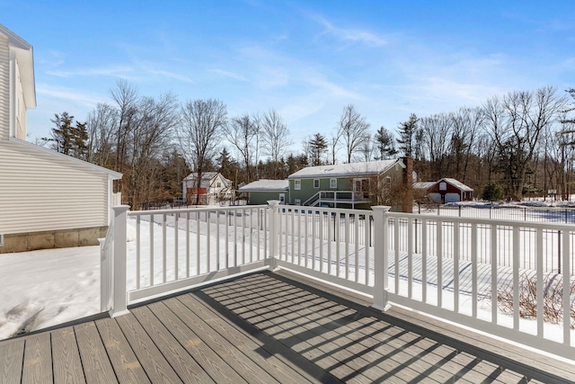 snow covered deck featuring an outdoor structure