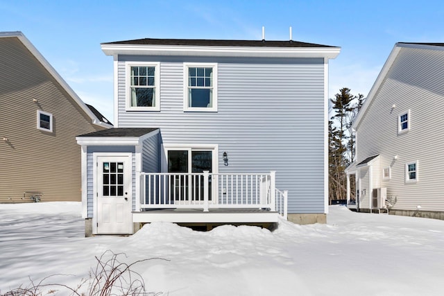 view of snow covered rear of property