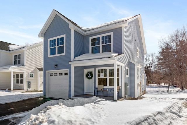 traditional-style house featuring a porch and an attached garage