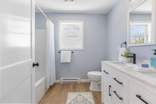 full bathroom featuring baseboards, toilet, wood finished floors, vanity, and a baseboard heating unit