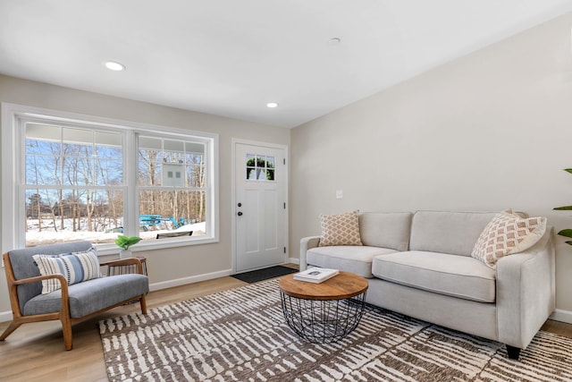 living room featuring recessed lighting, light wood-type flooring, and baseboards