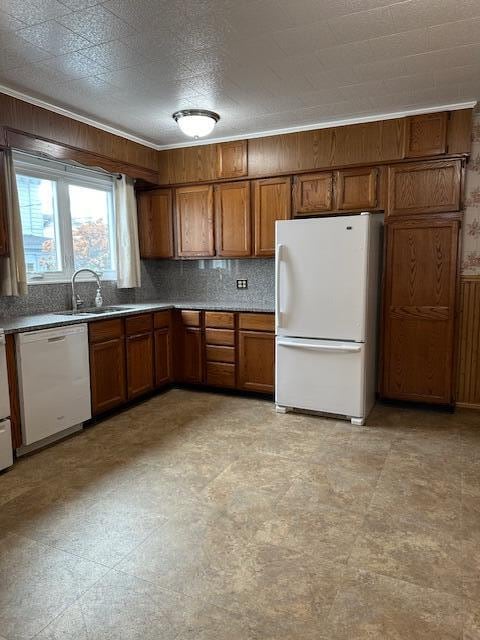 kitchen featuring decorative backsplash, sink, and white appliances