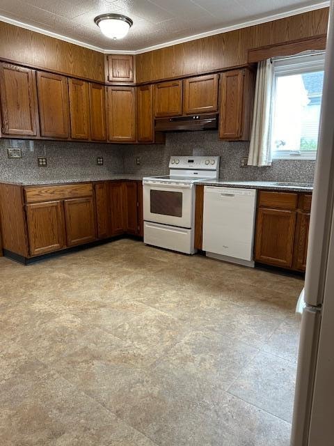 kitchen featuring white appliances and backsplash