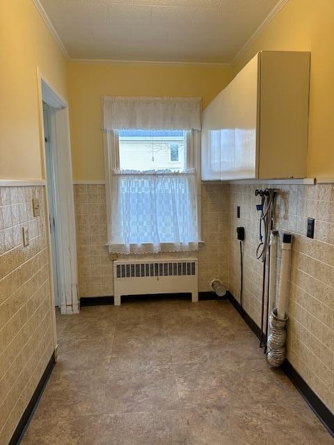 bathroom featuring radiator heating unit, tile walls, and ornamental molding