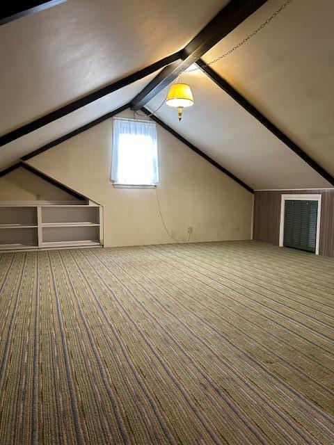 bonus room with vaulted ceiling with beams and carpet