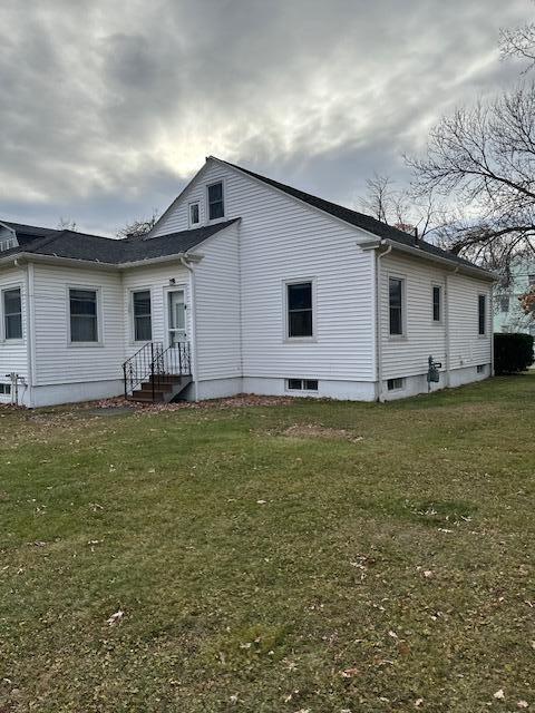 rear view of house with a lawn