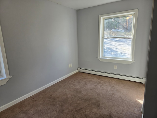 carpeted empty room with a wealth of natural light and a baseboard heating unit