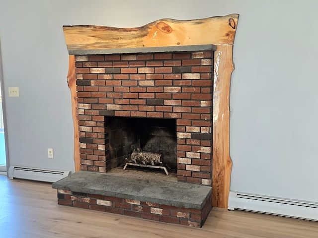 details with a fireplace, a baseboard radiator, and hardwood / wood-style flooring