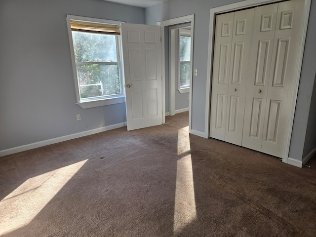 unfurnished bedroom with carpet floors and a closet