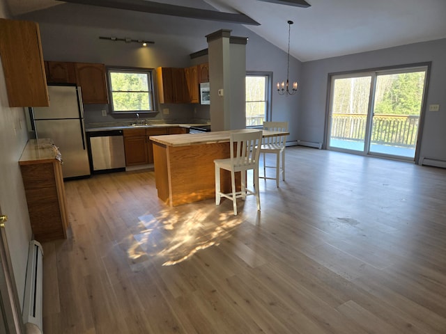 kitchen featuring light hardwood / wood-style flooring, a healthy amount of sunlight, and appliances with stainless steel finishes