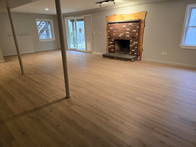 unfurnished living room featuring light wood-type flooring and a fireplace