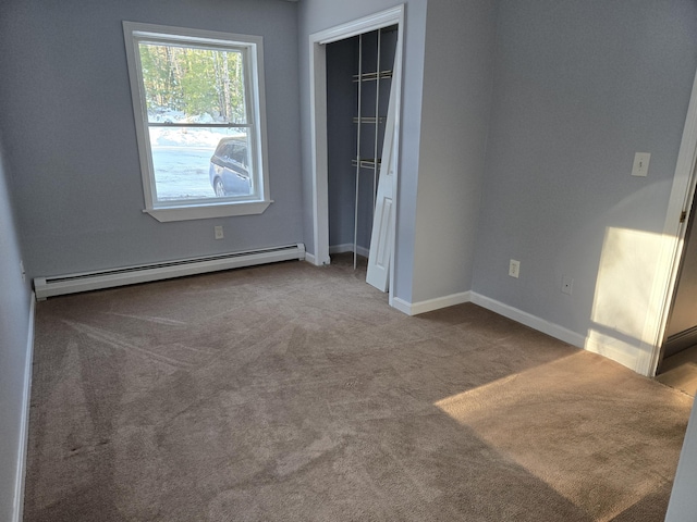 unfurnished bedroom with baseboard heating, a closet, and light colored carpet