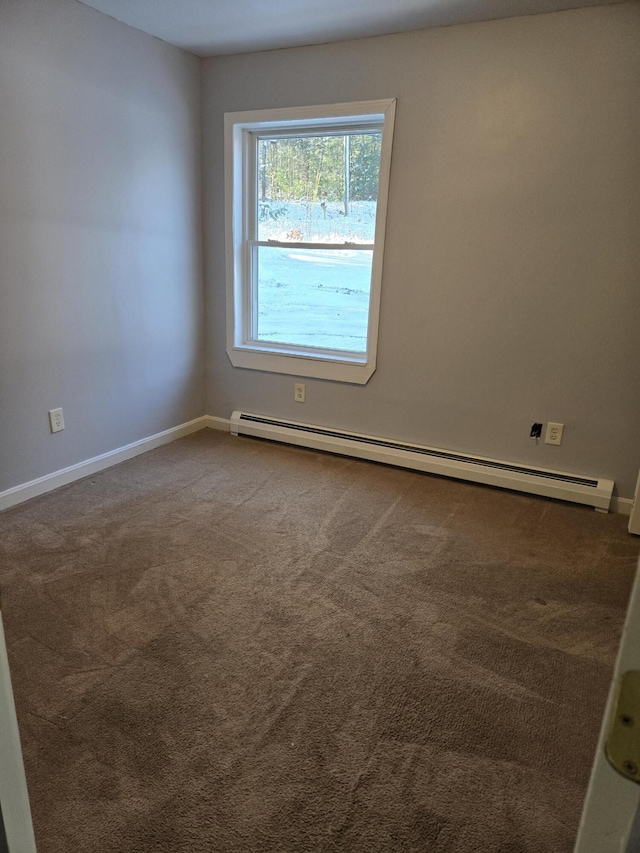 spare room featuring carpet floors and a baseboard radiator