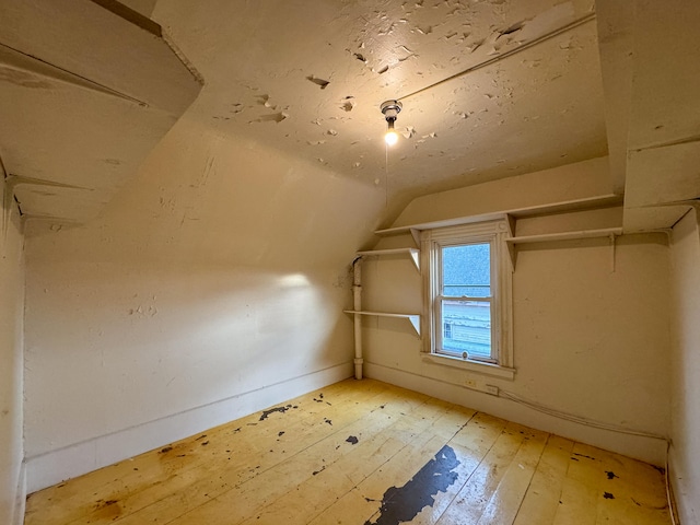 bonus room featuring lofted ceiling and hardwood / wood-style flooring