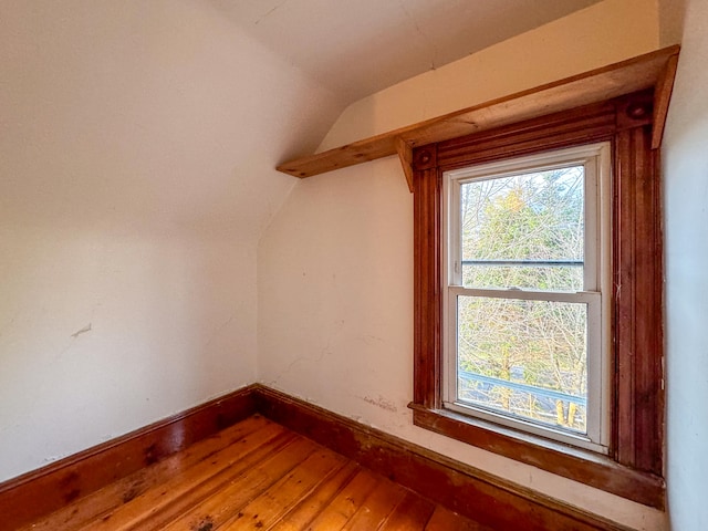 additional living space featuring hardwood / wood-style floors and vaulted ceiling