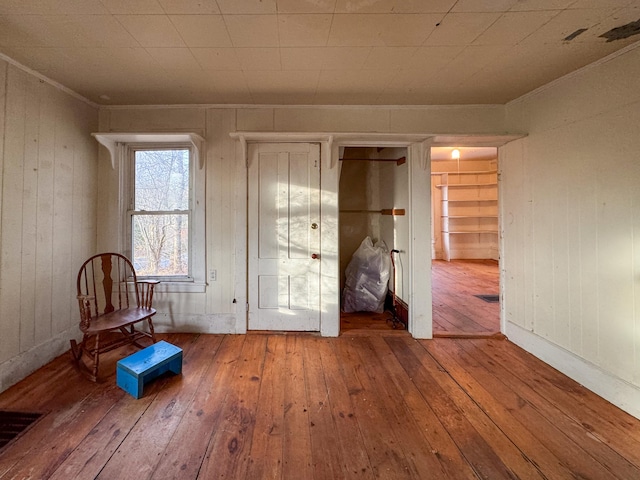 interior space featuring wood walls and hardwood / wood-style flooring