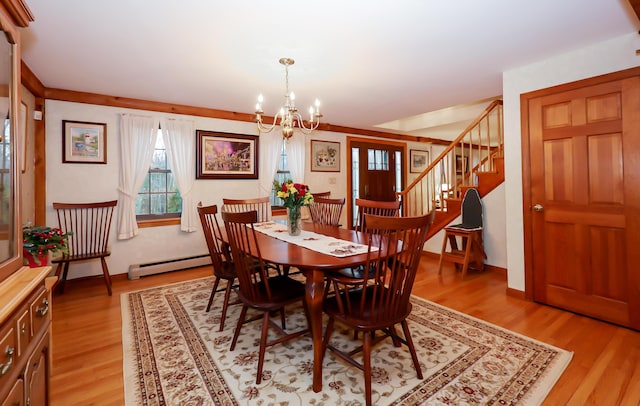 dining room featuring baseboard heating, a notable chandelier, and light wood-type flooring