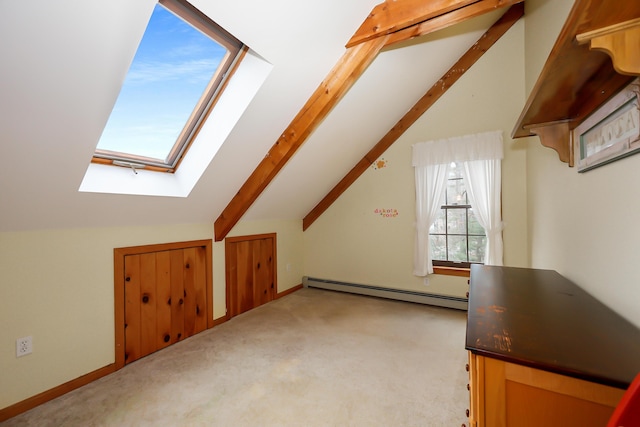 additional living space featuring vaulted ceiling with skylight, baseboard heating, and light carpet